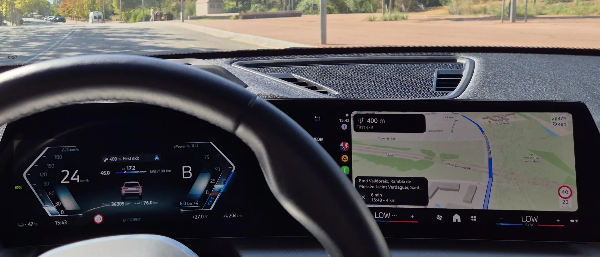 BMW iX1 dashboard: the driver display shows 47 % battery, and ABRP on the central screen shows the same 47 % live, with 46 % predicted on arrival.